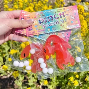 Photochromic animal squishy toy in colorful 'Pinch Family' retail display packaging