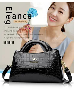 Elegant black crocodile pattern patent leather handbag featuring a gold kangaroo logo