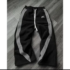 Black high-street style wide-leg sweatpants with white side stripes and drawstrings.