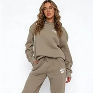 Detail view of taupe oversized hoodie and matching sweatpants with white logo