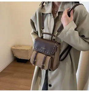 Model carrying a vintage European style color-block leather backpack with straps