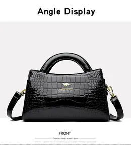 Front view of black crocodile pattern patent leather handbag with gold accents