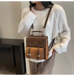 Retro brown faux leather backpack and handbag combo worn by a model in casual style
