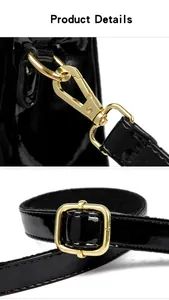 Close-up of golden hardware and glossy black patent leather strap on women's bag