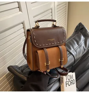Vintage brown faux leather backpack with contrast stitching and gold-tone hardware