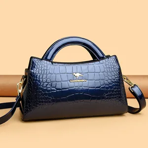 Navy blue crocodile pattern patent leather handbag with gold kangaroo logo and strap