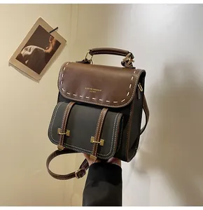 Retro faux leather backpack in brown and grey with top handle and stitched details