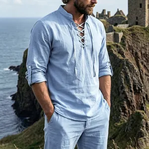 Detail of men's medieval light blue linen henley shirt with lace-up V-neck design
