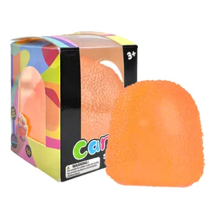 Vibrant orange jellyfish shaped squishy toy for stress relief in a colorful display box