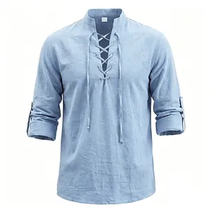 Detail view of light blue men's medieval lace-up linen shirt with rolled sleeves