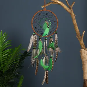 Handmade boho forest style dreamcatcher hanging ornament with green and brown feathers