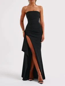 Elegant black strapless evening gown featuring high side slit and ruched bodycon fit.