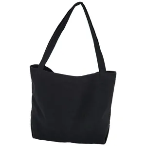 Minimalist black canvas tote bag for college students featuring durable shoulder straps
