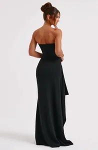 Back view of sexy black strapless maxi dress with side drape and slit detail.