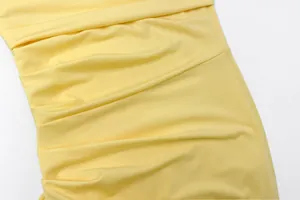 Detailed close-up showing texture of yellow ruched fabric on sexy summer bodycon strapless dress