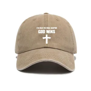 Detail of washed khaki baseball cap with white cross and God Wins religious print text