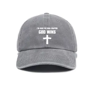 Detailed view of religious cross and slogan print on washed gray baseball cap
