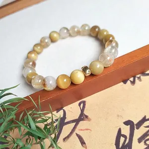 Close-up of a natural yellow tiger's eye and citrine beaded bracelet for women