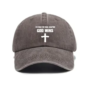 Detail view of God Wins slogan and cross embroidery on a washed gray cotton baseball cap