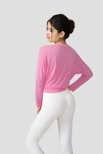 Detail of pink slub yarn yoga top showing breathable fabric and loose fit for fitness.
