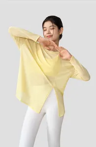 Macro detail shot of a lightweight slub yarn yoga top featuring a side slit in soft yellow