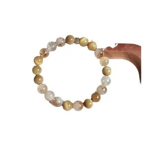 Natural tiger eye and rutilated quartz beaded bracelet with gold-toned spacer bead