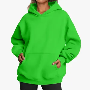 Detail shot of a vibrant neon green oversized women's hoodie with a front kangaroo pocket.