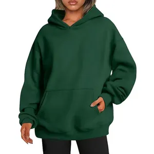 Close-up of the front pocket on a dark green oversized hoodie sweatshirt for women