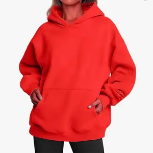 Detailed view of bright red oversized women's hooded sweatshirt with front pocket.