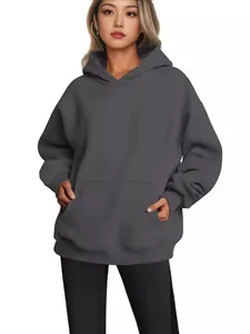 Oversized women's hooded sweatshirt in charcoal grey featuring a front kangaroo pocket design