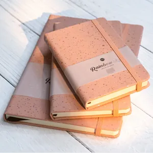 Detailed view of peach speckled A5 and A6 hardcover notebooks with elastic bands