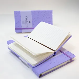 Detailed view of the purple glitter hardback notebook showing lined pages and elastic strap