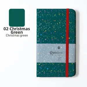 Detail view of A5 Christmas green glitter notebook with red elastic strap and rainbow sleeve