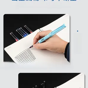Close-up of ergonomic blue fountain pen writing on notebook with ink cartridges.