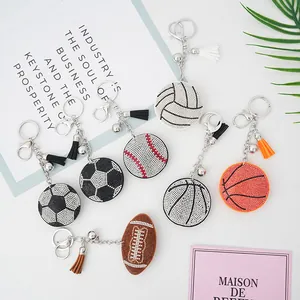 Close-up of sports-themed rhinestone soccer and basketball keychains with decorative tassels