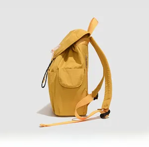 Detailed side view of a minimalist yellow nylon backpack for casual daily commuting
