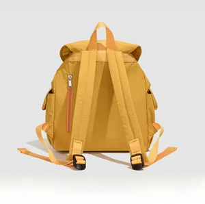 Detail view of the back of a bright yellow nylon casual backpack with sturdy straps