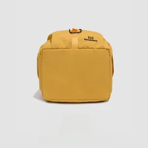 Detailed bottom view of a mustard yellow nylon casual backpack for commuting and outdoor use