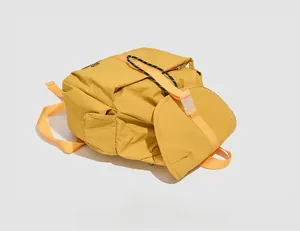 Detailed flat lay view of a yellow trendy casual backpack for campus and outdoor use.
