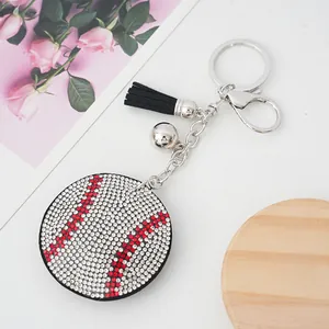 Close-up of a sparkling rhinestone baseball keychain featuring a black tassel and silver bell