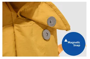 Detail view of the durable magnetic snap button closure on a yellow nylon casual backpack