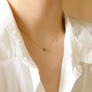 Close-up of 14K gold plated sterling silver necklace with emerald square pendant.