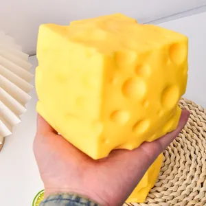 Large realistic Swiss cheese squishy toy held in hand for stress relief demonstration.