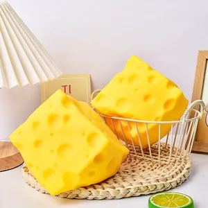 Detailed view of large simulated cheese squeeze toys with realistic holes.