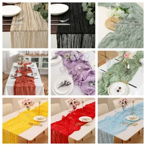 Collection of wrinkled cheesecloth table runners in various colors for wedding decor