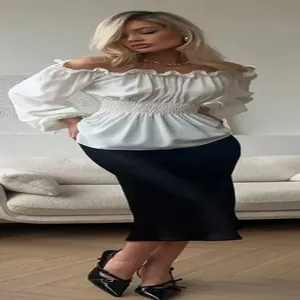 Elegant white off-shoulder long sleeve blouse with ruffled neckline and smocked waist