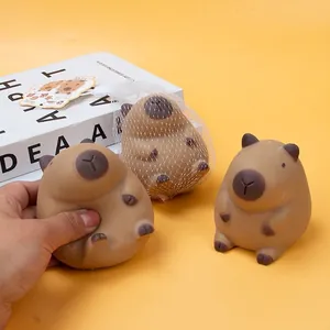 Close-up of brown capybara squeeze toy being hand-pressed to show soft slow-rising texture