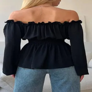 Detailed back view of a black off-the-shoulder long sleeve top with ruffle hem detail