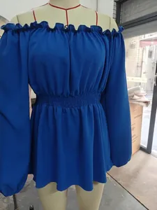 Detail of blue off-the-shoulder top with ruffled collar and cinched waist