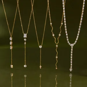 Detailed view of five gold-plated Y-shaped stainless steel necklaces with CZ stones.